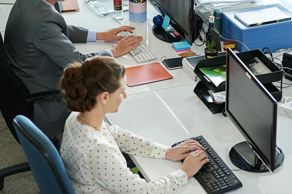 Shot of colleagues working on their computers while sitting in an office