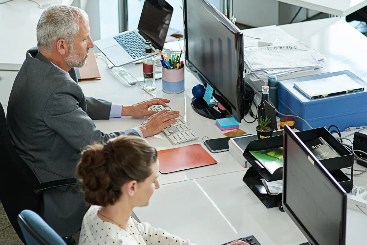 Shot of colleagues working on their computers while sitting in an office