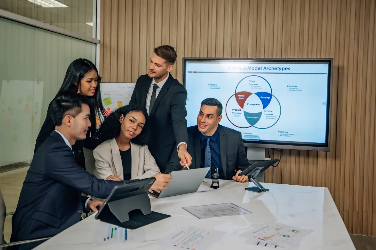 Team in a office looking over graphs in a meeting